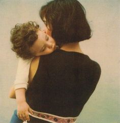 a woman holding a child in her arms