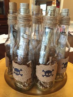 there are many empty glass bottles with pirate labels in them on the table, along with other items