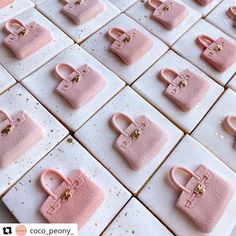 many small pink purses are arranged on white tiles with gold fleckers and beads