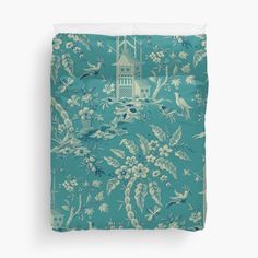 a blue and white floral pattern with birds on it duvet cover featuring an image of a clock tower in the background