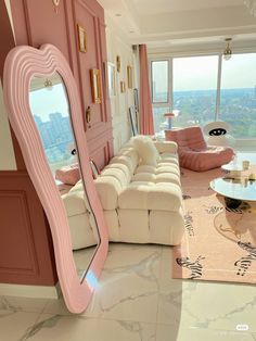 a living room filled with furniture and a large mirror on the wall next to a window