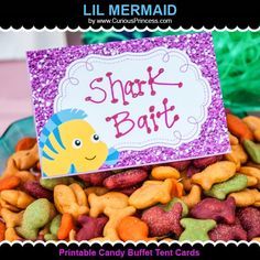 there is a sign that says shark bait on top of some cookies and candies