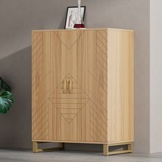 a wooden cabinet sitting next to a potted plant