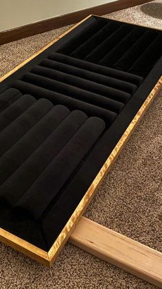 an inflatable mattress sitting on the floor next to a wooden frame and carpet