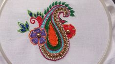 a close up of a embroidery on a piece of cloth