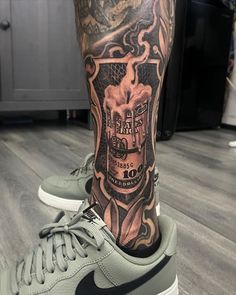 a man's leg with a tattoo on it and his nike air force sneakers