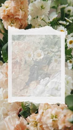 an old photo frame surrounded by white and pink flowers