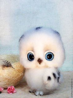 a stuffed owl sitting next to a small bird