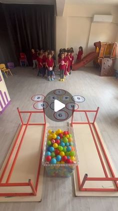 a group of children playing with colorful balls