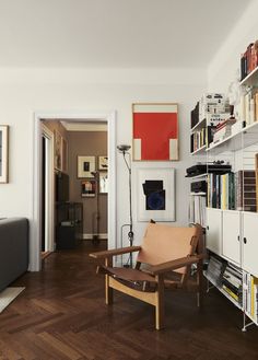 a living room filled with furniture and lots of books