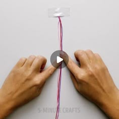 two hands are pulling the string together