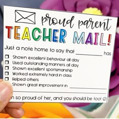 a person holding up a teacher mail card