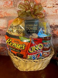 a basket filled with candy and snacks sitting on top of a table next to books