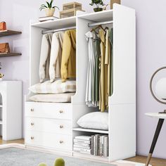 a white closet with clothes hanging on the doors and shelves above it in a living room