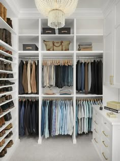 an organized closet with white shelving and lots of clothes on shelves, including shoes