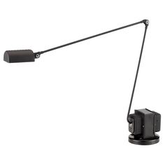 a desk lamp with a black base and one light on the arm is turned on