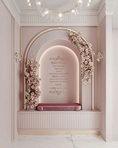 a pink and gold wedding ceremony with flowers on the wall, an arch to the aisle