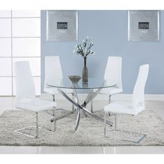 a glass dining table with white chairs and a vase filled with flowers on the top