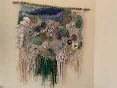 a wall hanging made out of shells and other things