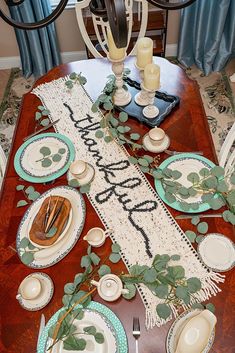 the table is set with plates and place settings