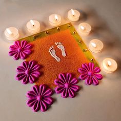 a decorated mat with candles and feet on it