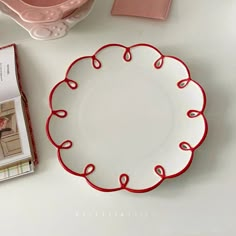 a white plate sitting on top of a table next to a cup and saucer