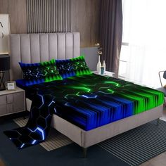 a bed with green and blue sheets in a room