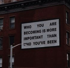 a sign on the side of a building that says, who you are becoming is more important than 40 you've been