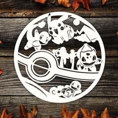 an image of some cartoon characters on a wooden surface with leaves and autumn leaves around it