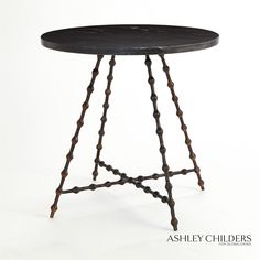 a small black table with metal legs and a wooden top on an isolated white background