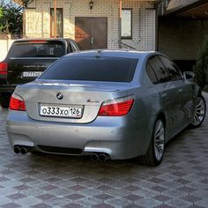 two cars parked next to each other in front of a house