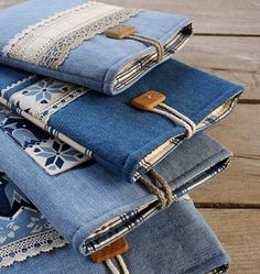 several pairs of jeans stacked on top of each other