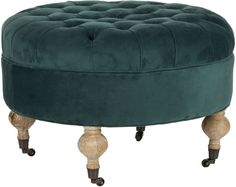 a green velvet ottoman with wooden legs and casteors on an isolated white background photo