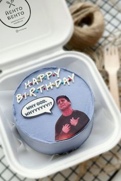 a birthday cake in a plastic container with a happy birthday message on the side and a fork next to it