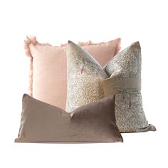 three pillows with decorative designs on them