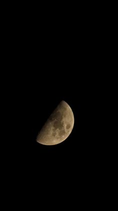 the moon is seen in the dark sky with only one light on it's side