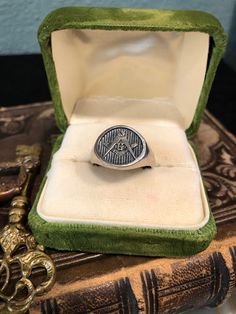 This is a beautiful vintage silver classic Freemason oval signet ring. Front has Masonic symbols G and compass.  Interior stamped with classic checkered board design, which is also Freemason symbol. On ring mandrel Approx size 12 1/2, size approximately  Weights Approx 9.86 grams  Inside band marked 925 This ring is vintage and has wear, patina, and scuffs/scratches. Please see all pictures and video.  This sale is for ring only, any other items shown are for decor and scale purposes only and ar Freemason Symbol, Checkered Board, Masonic Gifts, Freemason Ring, Ring Mandrel, Masonic Symbols, Make Easy Money, Mystery Book, Ring Oval