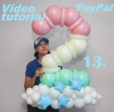 a woman is holding balloons in front of a sign that says video tutorial pay pal