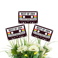 flowers in a vase with three best of 1994 stickers