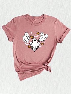 Introducing our Ghost Heart Shirt, the perfect addition to your spooky season wardrobe! This Halloween-inspired t-shirt features a captivating design that combines the ghostly elements of the season with a touch of cuteness. Get into the Halloween spirit with this Scary Ghost Shirt, which features a friendly ghost, hearts, and all the elements of a fun and memorable Halloween night. The vibrant colors and playful design make it a must-have for the Halloween party or as a Halloween gift for your Horror Themed Short Sleeve T-shirt For Fall, Halloween Horror Short Sleeve T-shirt, Fun Halloween Short Sleeve Shirt, Horror Style Short Sleeve T-shirt For Fall, Halloween Horror Cotton T-shirt, Halloween Crew Neck Top With Character Print, Spooky Cartoon Print T-shirt For Fall, Halloween Character Print Pink Top, Trendy Halloween Short Sleeve T-shirt