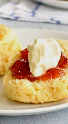 two biscuits with jam and whipped cream on top