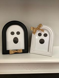 two white frames with black and gold decorations