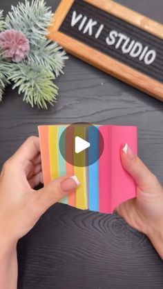 someone is holding up a card with the word vivid on it and an image of a rainbow