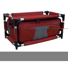 a red baby crib with two black handles and an extra gray handle on the side