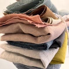 a stack of different colored linens sitting on top of each other