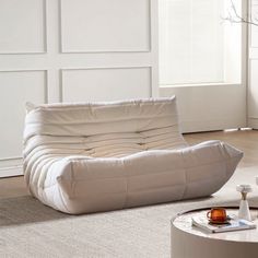 a white couch sitting on top of a rug in a living room