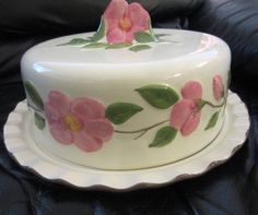 a white cake with pink flowers painted on it