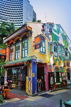 the colorful building has many windows on it's sides and is painted with cartoon characters