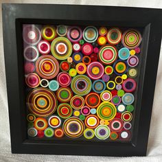 an art work made out of various colored circles in a black frame on a white background