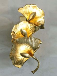 two gold flowers on a white background